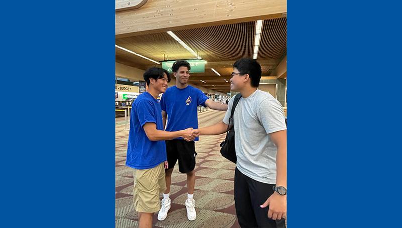Two friendly LCC employees welcome an international student at the Eugene Airport