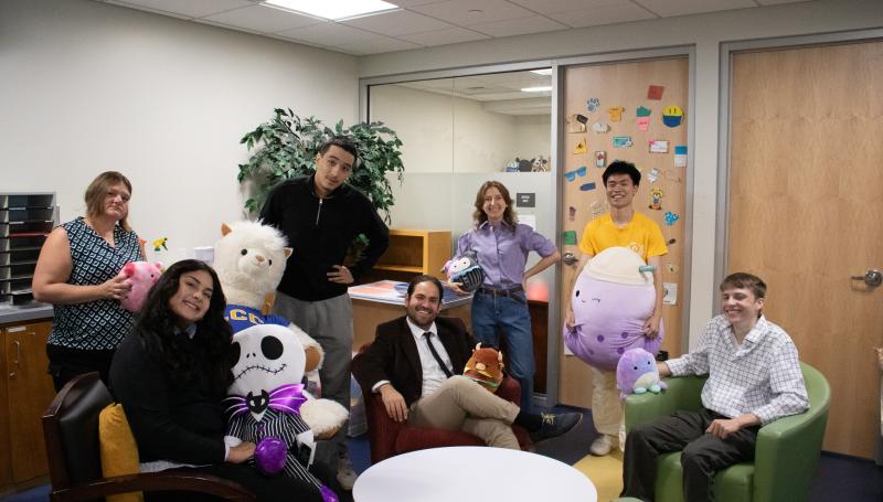 the 2025-2026 student government officials smiling and posing with giant stuffed animals in the SGA office