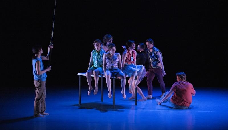 LCC students performing contemporary dance on a dramatically lit stage