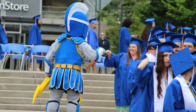 ty the titan giving a graduating student a high five