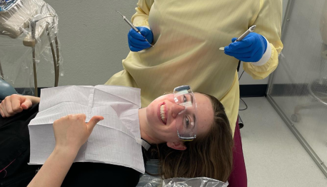 dental hygiene student practices on another student in a clinic