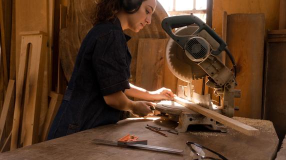 Carpenter cutting a board for a construction project