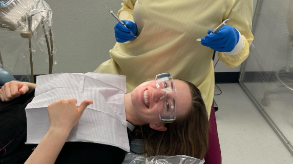 dental hygiene student practices on another student in a clinic