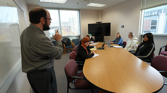 business instructor Corey Murphy teaching a small class