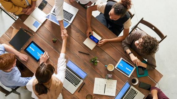 top view of people working at a table together