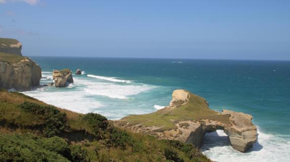 a beach with striking rock formations in New Zealand