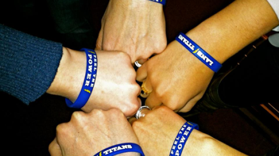 An overhead photo of the hand and wrists of five Lane Community College students.