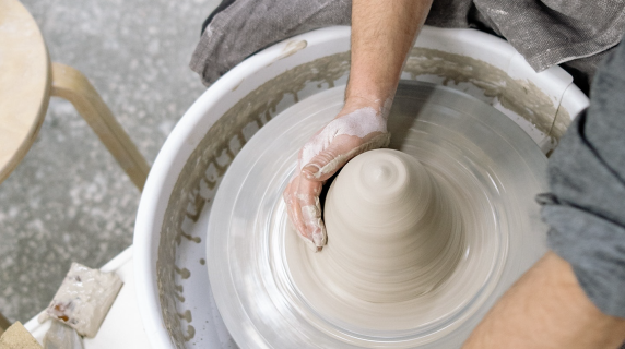 person using a pottery wheel