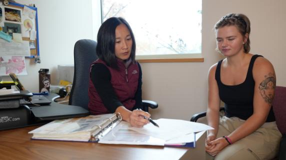 A woman advising a young woman