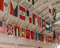 flags from around the world displayed on the sunny ceiling of Building 1 at LCC