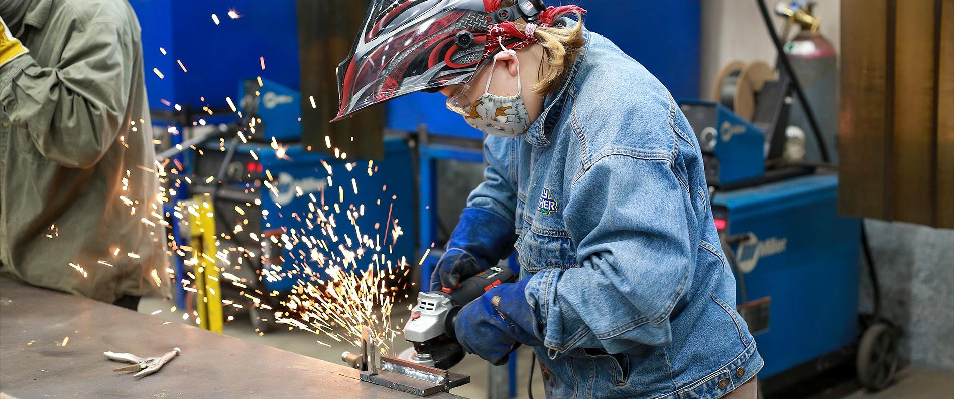 person welding with sparks flying out
