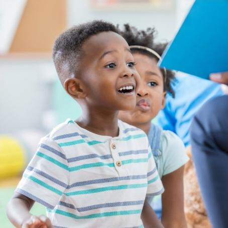 two kids smiling and looking to the right